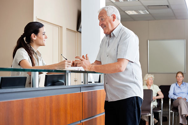 Patient Service Representative helping patient