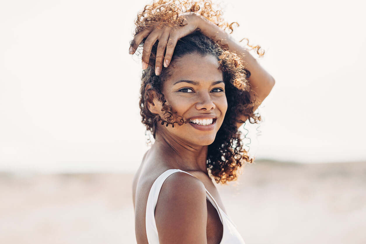 iStock-1217412013 (1) Smiling woman at the beach